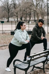 man and woman exercising on the bench